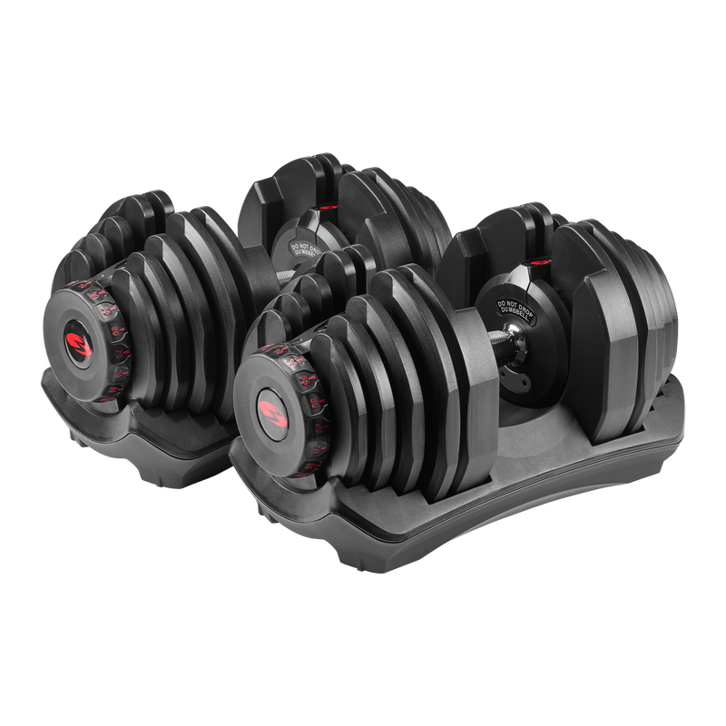 Bowflex SelectTech dumbbell in black with red accents, a white background as a backdrop.